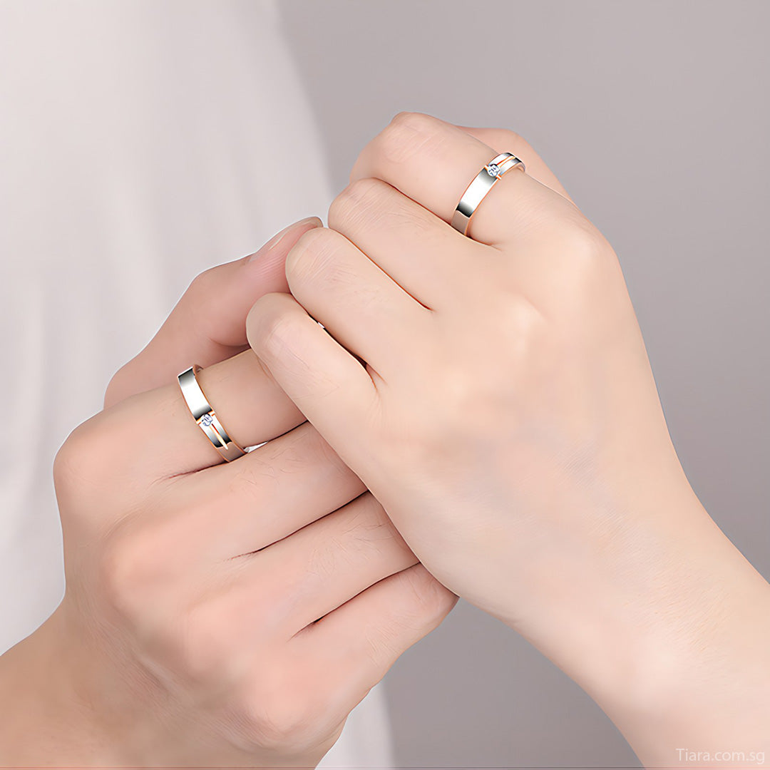 couple trying on rings