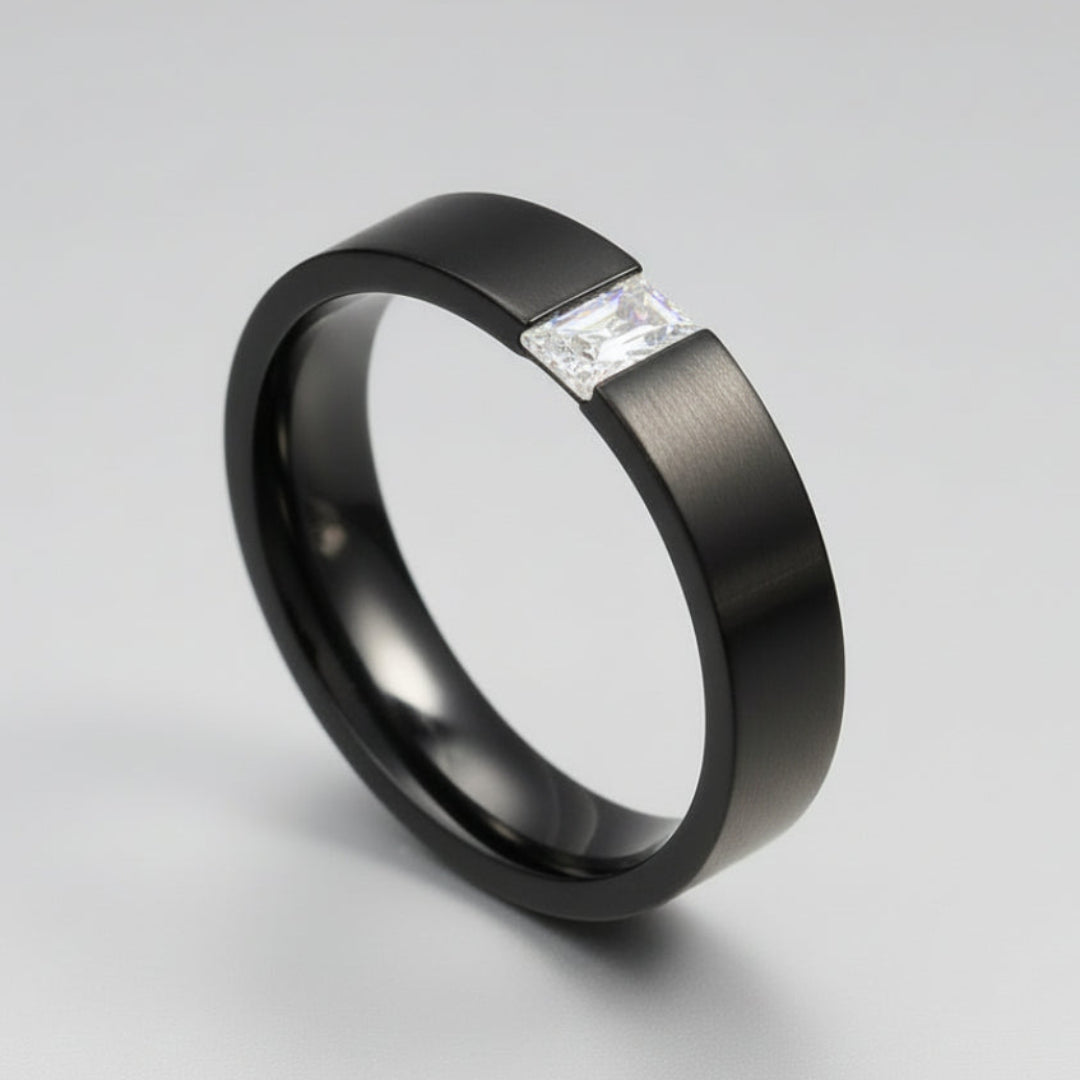 A black stainless steel ring with a square-shaped top grade cubic zirconia, displayed on a dark background.
